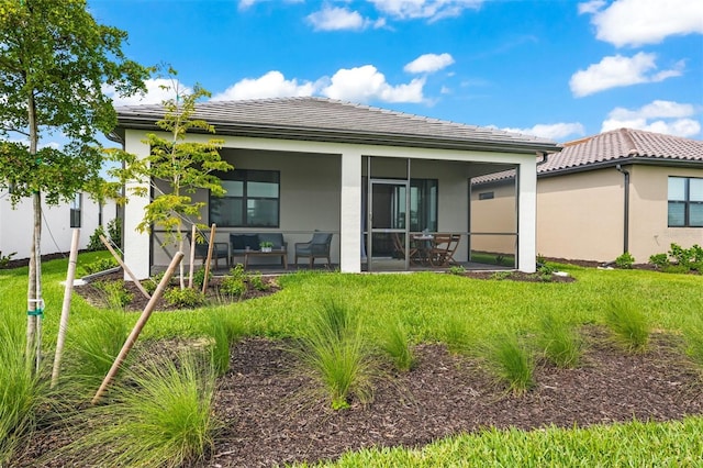 rear view of house with a lawn