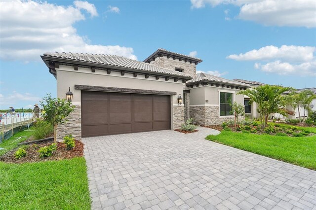 mediterranean / spanish-style house with a front lawn and a garage