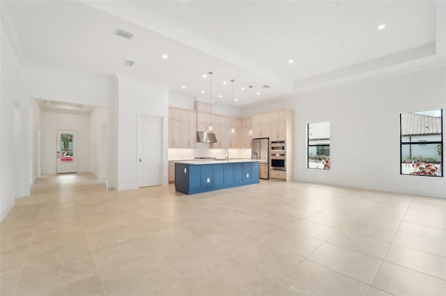 unfurnished living room featuring light tile patterned flooring, a high ceiling, and sink