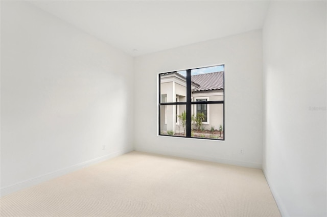 empty room featuring light carpet