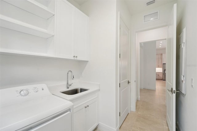 laundry area with sink, light tile patterned floors, cabinets, and washer / dryer