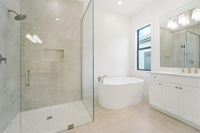 bathroom featuring tile patterned flooring, vanity, and separate shower and tub