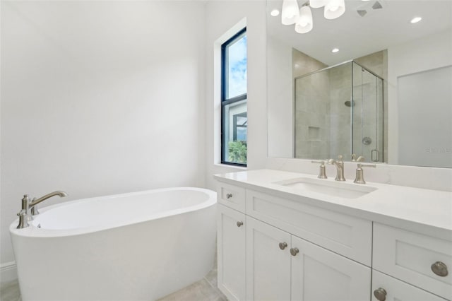 bathroom featuring separate shower and tub and vanity