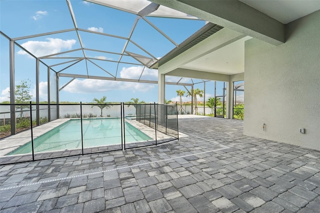 view of pool featuring a patio area and glass enclosure