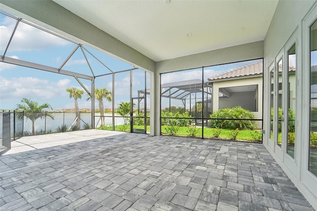 unfurnished sunroom with a water view