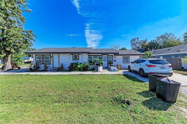 ranch-style home with a front lawn