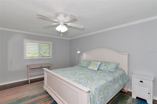 bedroom with crown molding, dark hardwood / wood-style flooring, and ceiling fan