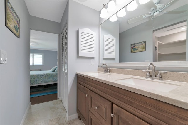 bathroom with double sink vanity, tile floors, and ceiling fan