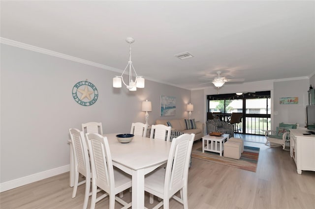 dining room featuring ornamental molding, ceiling fan with notable chandelier, and light hardwood / wood-style flooring