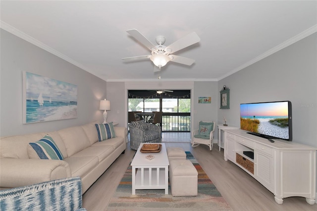 living room with ornamental molding, ceiling fan, and light hardwood / wood-style flooring