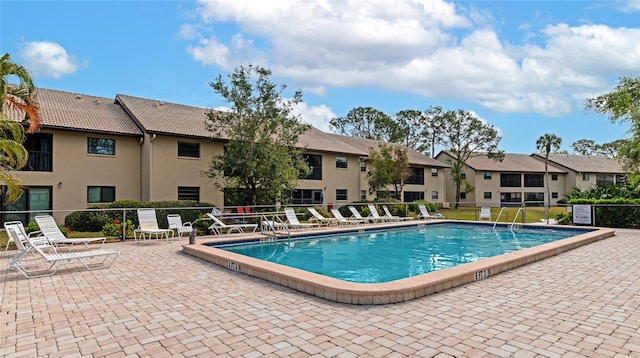 view of swimming pool featuring a patio area