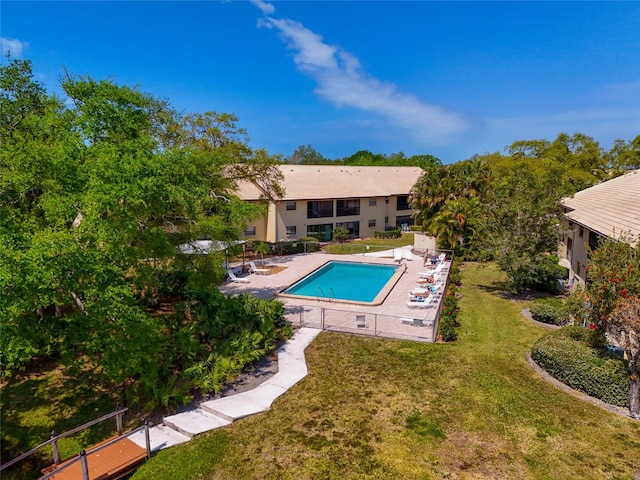 view of swimming pool with a yard and a patio area