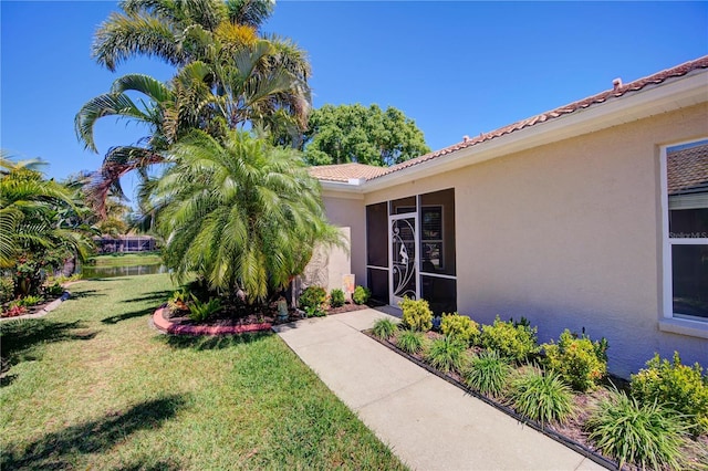 property entrance with a lawn