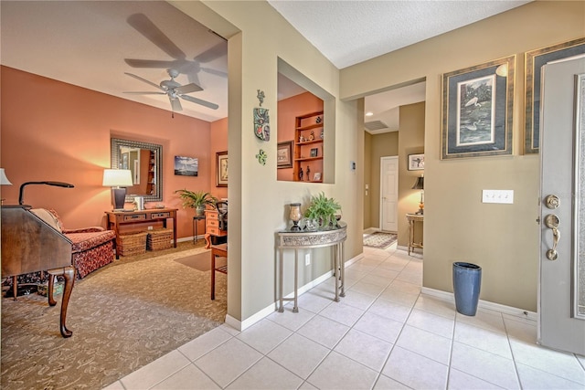 interior space featuring a textured ceiling, light tile flooring, and built in features