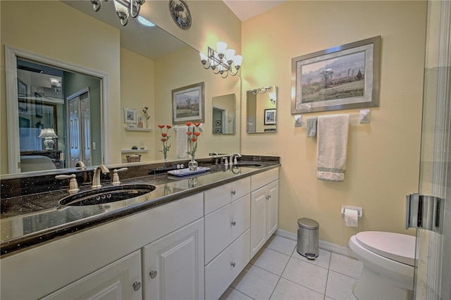 bathroom featuring large vanity, tile floors, toilet, and double sink