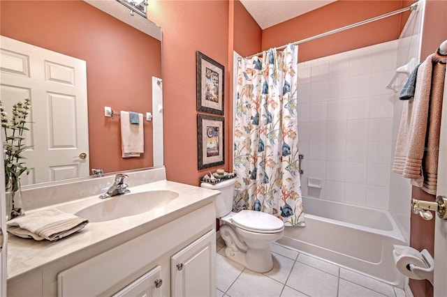 full bathroom featuring shower / tub combo, tile floors, large vanity, toilet, and a textured ceiling