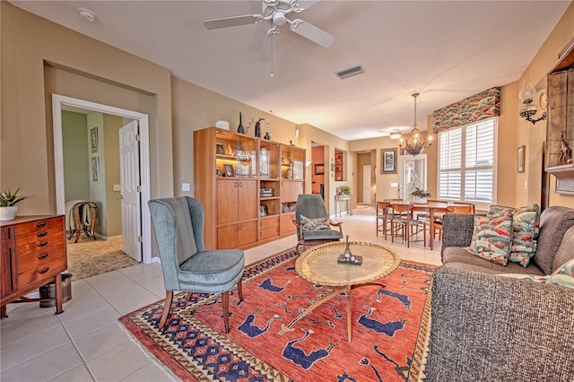 carpeted living room featuring ceiling fan with notable chandelier