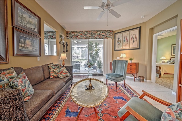 tiled living room with ceiling fan and a textured ceiling