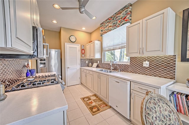 kitchen with backsplash, ceiling fan, dishwasher, sink, and light tile floors