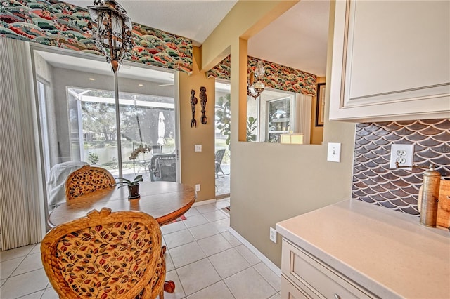 kitchen featuring white cabinetry and light tile floors