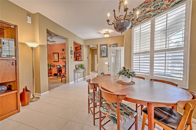 dining area featuring a notable chandelier and light tile floors