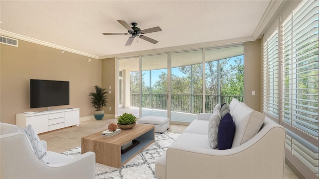 401 N Point Rd Unit 301, Osprey, FL 34229 - living room featuring expansive windows, ceiling fan, a textured ceiling, and crown molding