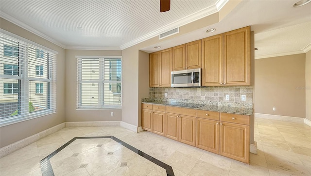 401 N Point Rd Unit 301, Osprey, FL 34229 - kitchen featuring light tile floors, tasteful backsplash, ceiling fan, and a healthy amount of sunlight
