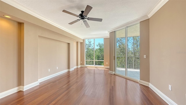 401 N Point Rd Unit 301, Osprey, FL 34229 - unfurnished room with floor to ceiling windows, a textured ceiling, ceiling fan, and dark hardwood / wood-style flooring