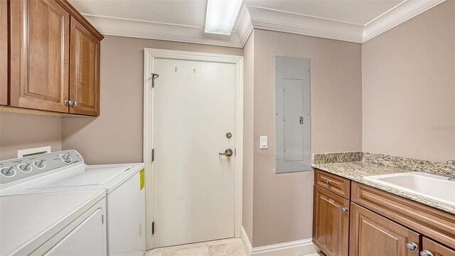 401 N Point Rd Unit 301, Osprey, FL 34229 - laundry area with sink, light tile floors, ornamental molding, washing machine and clothes dryer, and cabinets