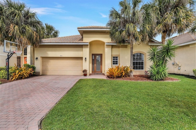 mediterranean / spanish house featuring a front yard and a garage