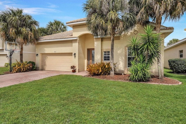 mediterranean / spanish-style home featuring a front yard and a garage