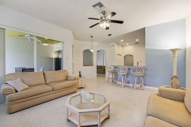 living room with ceiling fan and light tile floors