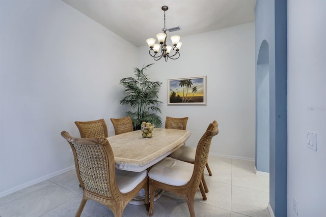 dining room featuring a notable chandelier and light tile floors