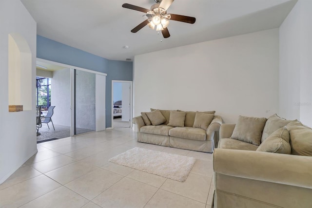 living room with light tile floors and ceiling fan