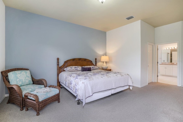 carpeted bedroom with ensuite bath