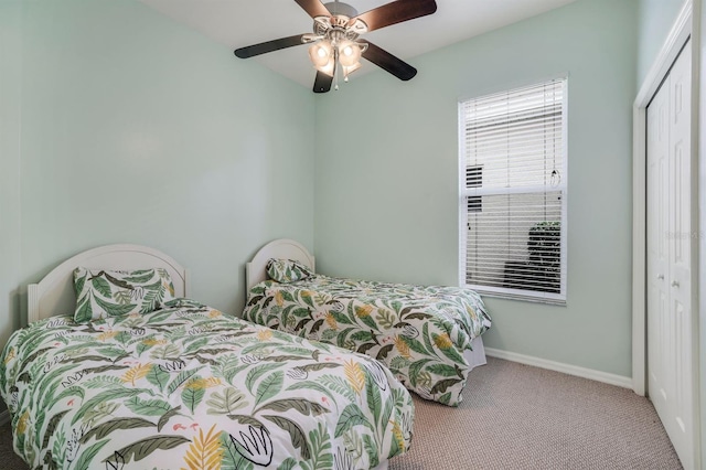 carpeted bedroom with a closet and ceiling fan