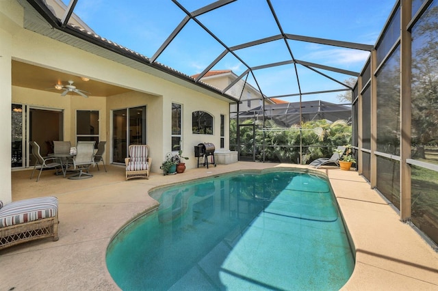 view of swimming pool with area for grilling, a lanai, ceiling fan, and a patio area