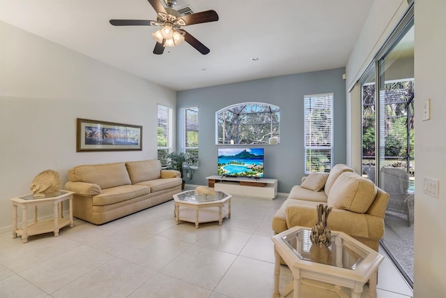 living room featuring a ceiling fan, visible vents, a wealth of natural light, and light tile patterned flooring