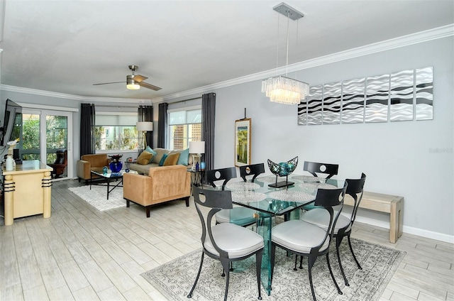 dining room featuring plenty of natural light, crown molding, light hardwood / wood-style flooring, and ceiling fan with notable chandelier