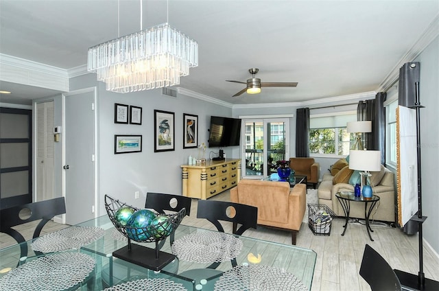 living room featuring french doors, light hardwood / wood-style floors, ornamental molding, and ceiling fan with notable chandelier