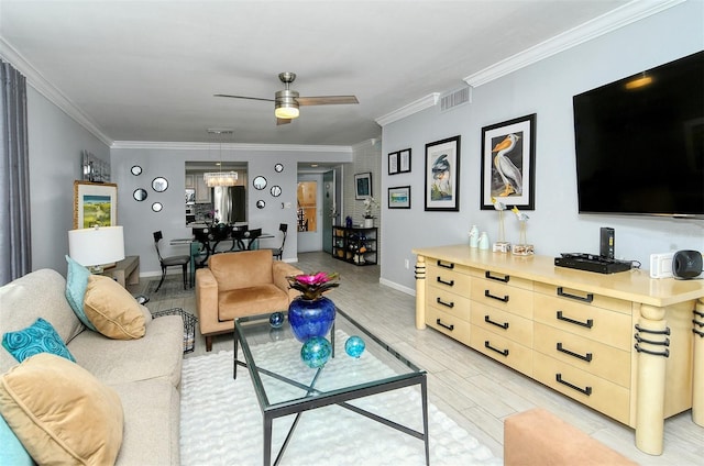 living room featuring ornamental molding, ceiling fan, and light wood-type flooring