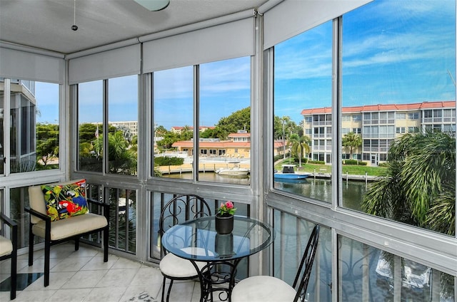 sunroom / solarium featuring a water view