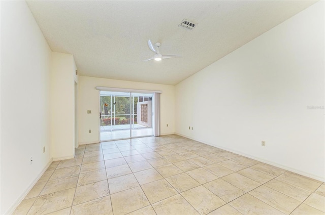 empty room with ceiling fan, a textured ceiling, and light tile floors