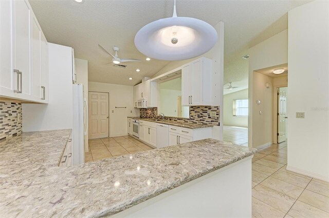 kitchen with white cabinetry, white appliances, vaulted ceiling, and ceiling fan