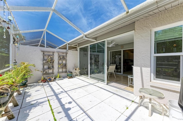 unfurnished sunroom featuring ceiling fan