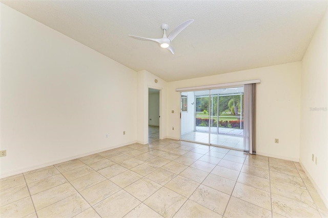 spare room with vaulted ceiling, ceiling fan, and light tile flooring