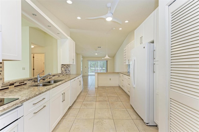 kitchen with sink, tasteful backsplash, white appliances, and white cabinetry