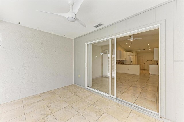 unfurnished room featuring ceiling fan and tile patterned floors