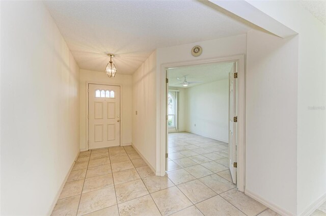 tiled foyer with a textured ceiling