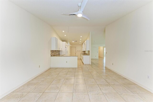 unfurnished living room featuring ceiling fan, a textured ceiling, and light tile patterned floors